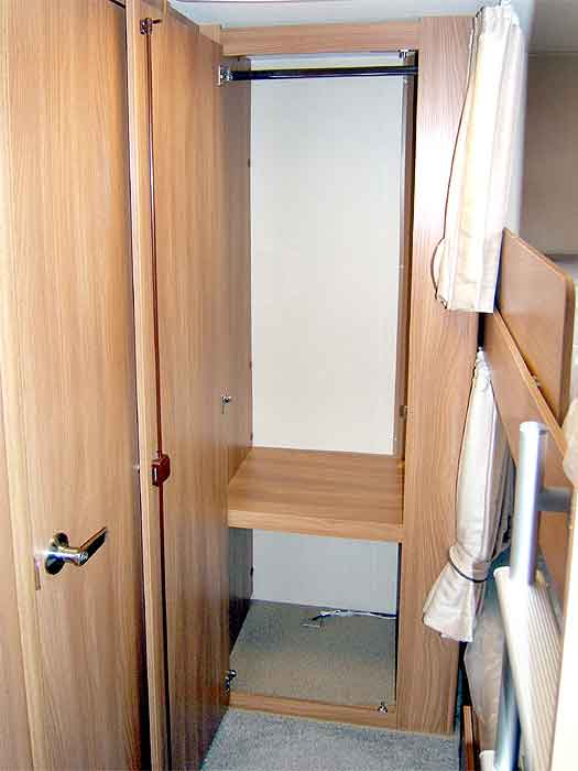 View of the large wardrobe's interior at the rear of the caravan.